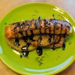 plated salmon on fried green tomatoes with balsamic reduction