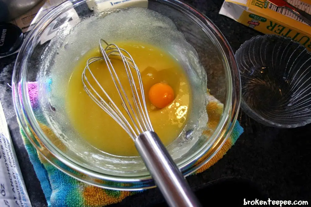 eggs and melted butter and sugar in bowl