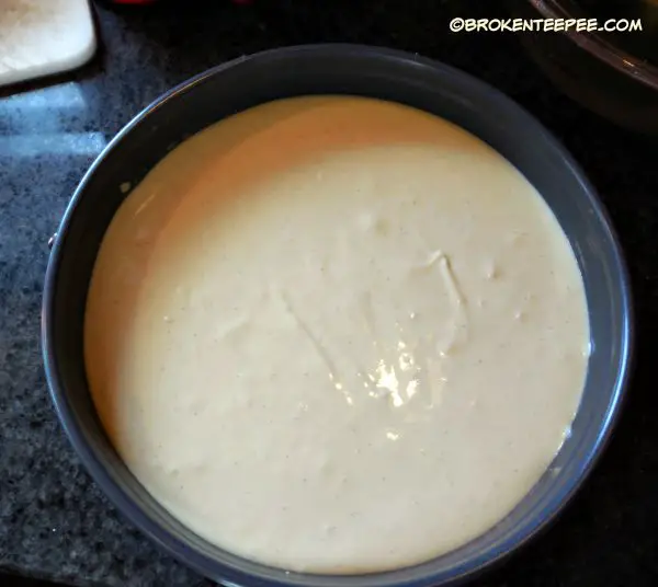 pour cheesecake batter over crust
