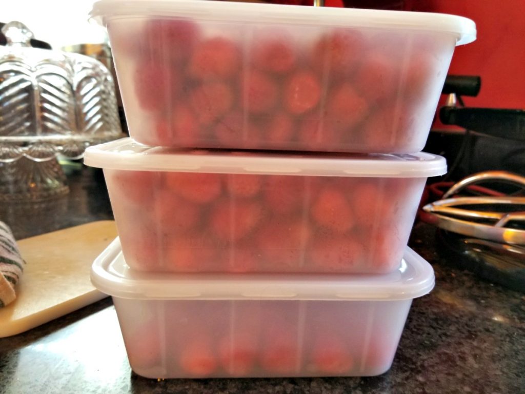 frozen strawberries in reusable containers